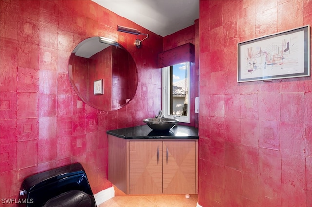 bathroom with tile patterned flooring, vanity, and tile walls