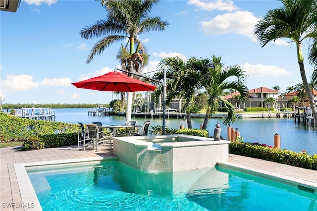 view of swimming pool featuring an in ground hot tub, a water view, and a patio