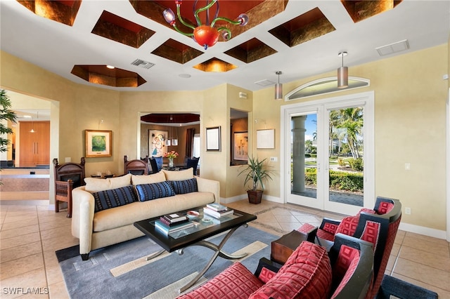 tiled living room featuring coffered ceiling and french doors