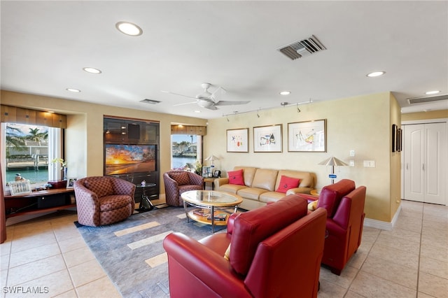 tiled living room featuring ceiling fan