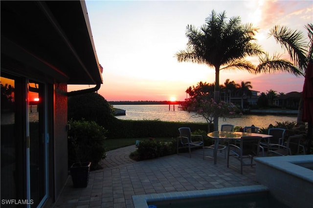 patio terrace at dusk with a water view