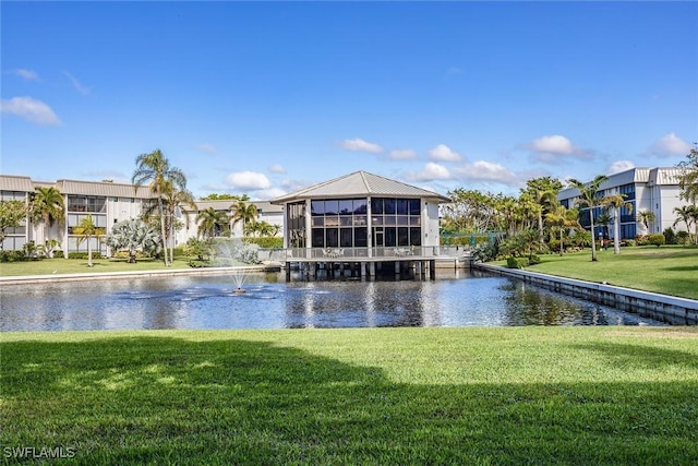 view of community with a water view and a lawn