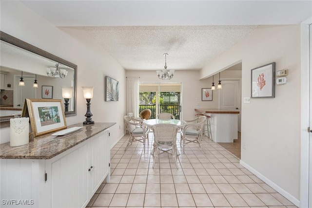 dining room with light tile patterned floors, a textured ceiling, and a chandelier