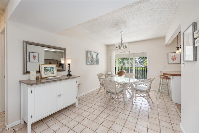 dining room with light tile patterned floors, a textured ceiling, and a notable chandelier