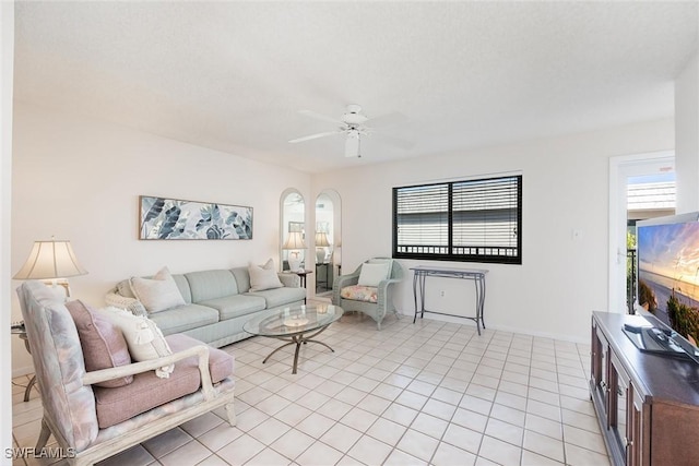 tiled living room with ceiling fan