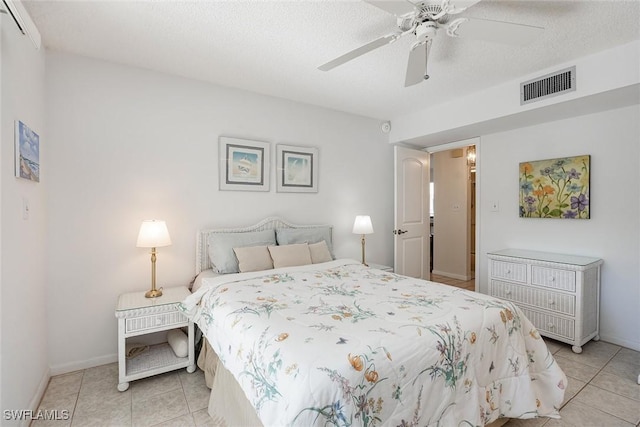 tiled bedroom featuring ceiling fan and a textured ceiling