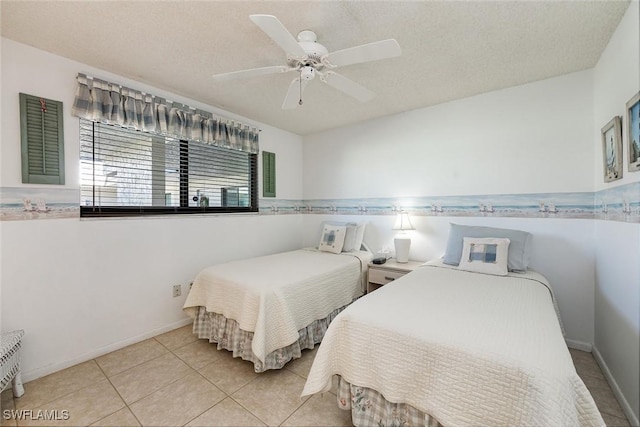 tiled bedroom featuring a textured ceiling and ceiling fan