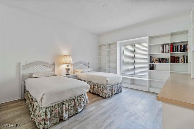 bedroom with wood-type flooring and a textured ceiling