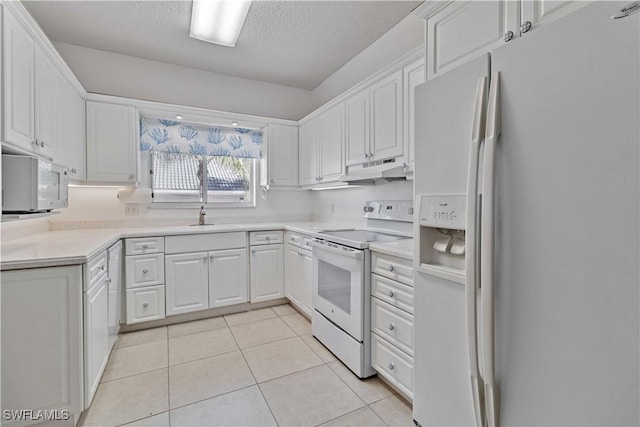 kitchen with white appliances, a textured ceiling, sink, light tile patterned floors, and white cabinets