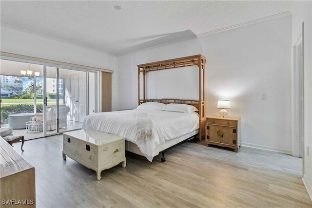 bedroom featuring a textured ceiling, access to outside, an inviting chandelier, and light hardwood / wood-style floors