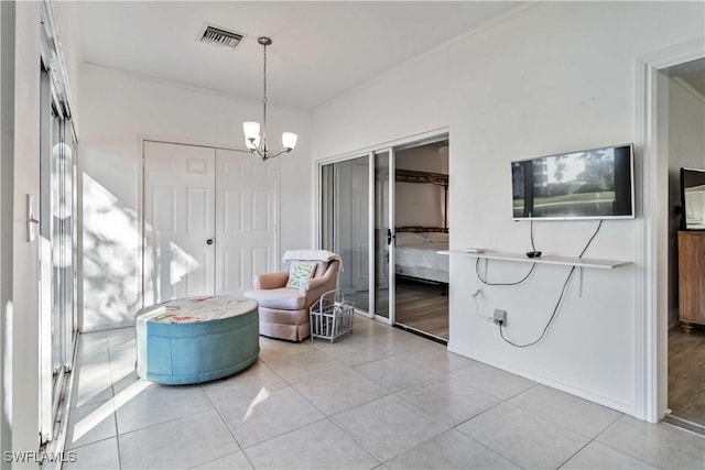 sitting room featuring a chandelier and light tile patterned floors