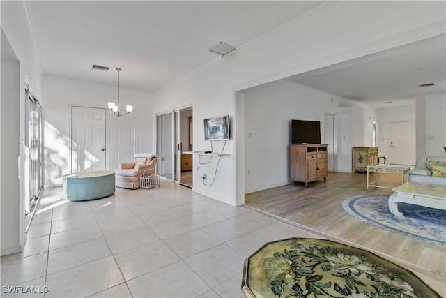 living room featuring light tile patterned floors and a chandelier