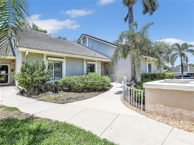 808 Arbor Lake Dr Unit 8-105, Naples, FL 34110 - view of front of home featuring stucco siding and a tile roof