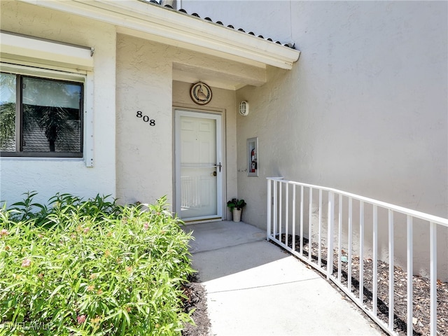 808 Arbor Lake Dr Unit 8-105, Naples, FL 34110 - view of exterior entry featuring stucco siding and covered porch