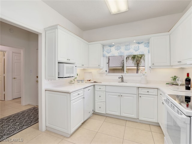 808 Arbor Lake Dr Unit 8-105, Naples, FL 34110 - kitchen featuring white appliances, white cabinetry, light tile patterned floors, and light countertops