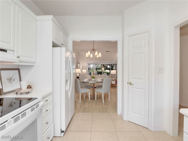 808 Arbor Lake Dr Unit 8-105, Naples, FL 34110 - kitchen featuring white refrigerator with ice dispenser, a chandelier, white cabinets, and light countertops