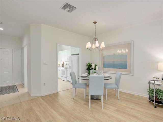 808 Arbor Lake Dr Unit 8-105, Naples, FL 34110 - dining space with a chandelier, light wood finished floors, and baseboards