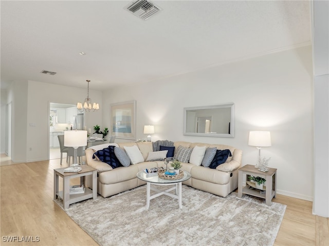 808 Arbor Lake Dr Unit 8-105, Naples, FL 34110 - living area with a chandelier, light wood-style floors, and baseboards