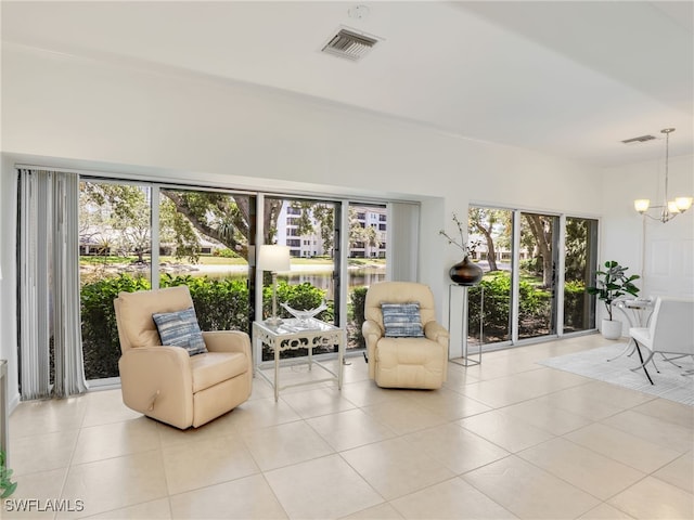 808 Arbor Lake Dr Unit 8-105, Naples, FL 34110 - living area with healthy amount of natural light, a chandelier, and light tile patterned flooring