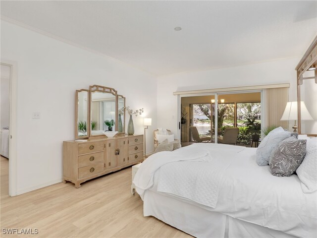 808 Arbor Lake Dr Unit 8-105, Naples, FL 34110 - bedroom featuring light wood-style floors, access to exterior, crown molding, and baseboards