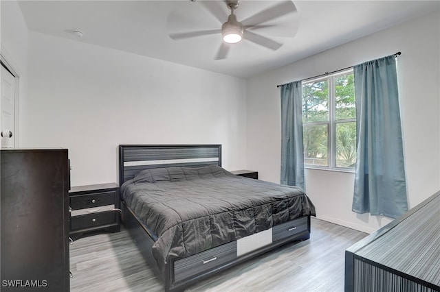 bedroom with light wood-type flooring and ceiling fan