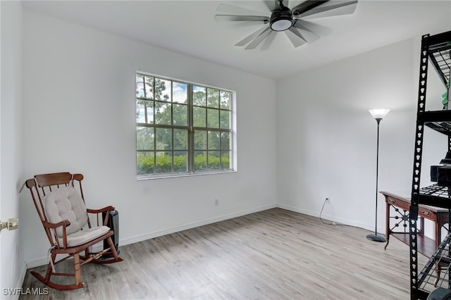 living area featuring ceiling fan and light wood-type flooring