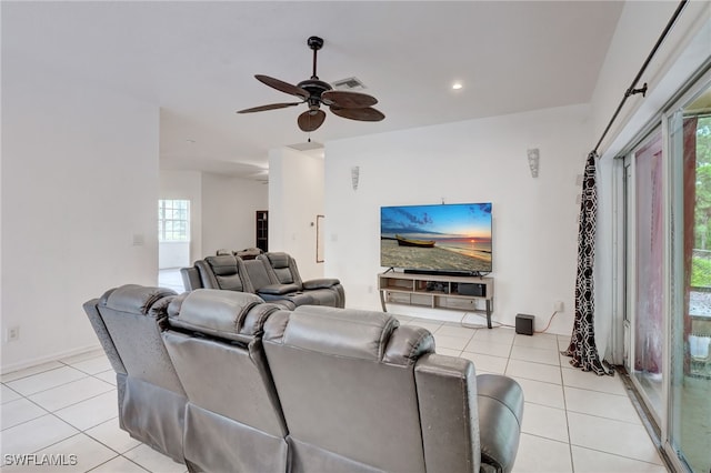 living room featuring light tile patterned floors, ceiling fan, and a healthy amount of sunlight