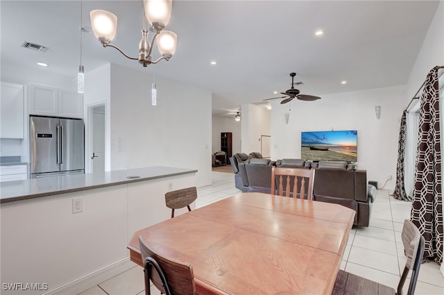 dining area featuring ceiling fan with notable chandelier and light tile patterned flooring