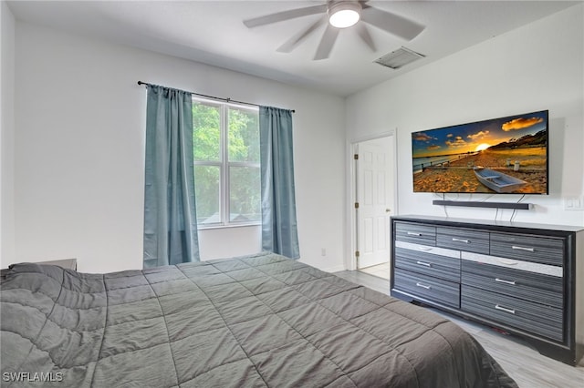 bedroom with ceiling fan and light hardwood / wood-style floors