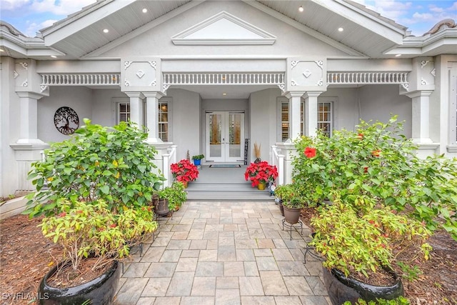 24720 Bay Bean Ct, Bonita Springs, FL 34134 - entrance to property featuring covered porch, french doors, and stucco siding
