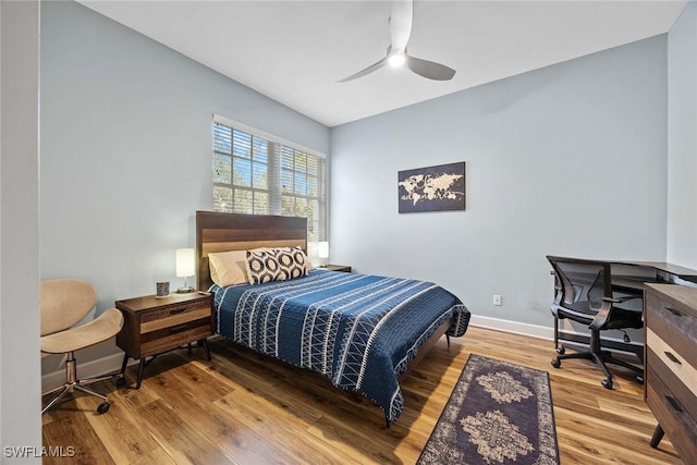 bedroom with hardwood / wood-style floors and ceiling fan