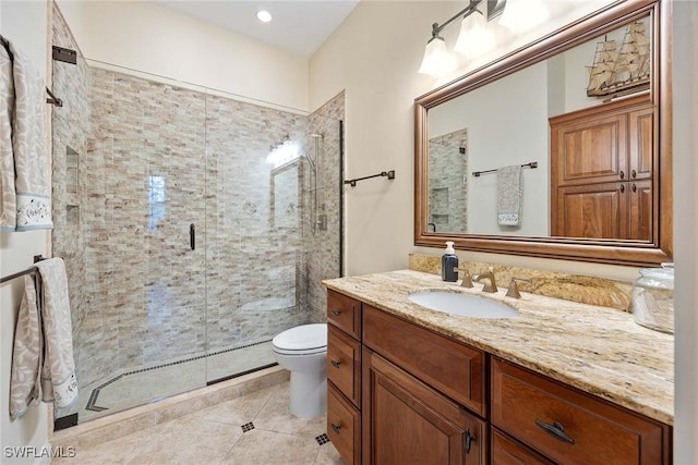 bathroom featuring tile patterned floors, toilet, vanity, and a shower with shower door