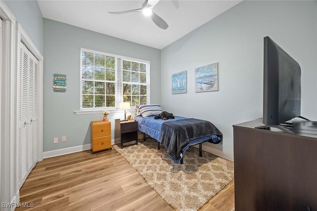 bedroom with a closet, ceiling fan, and wood-type flooring