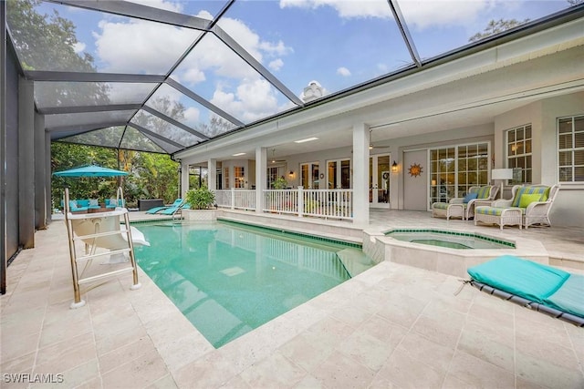 view of swimming pool with a patio area, an in ground hot tub, a lanai, and an outdoor hangout area