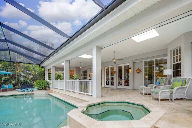 view of swimming pool with an in ground hot tub, ceiling fan, a patio area, and french doors