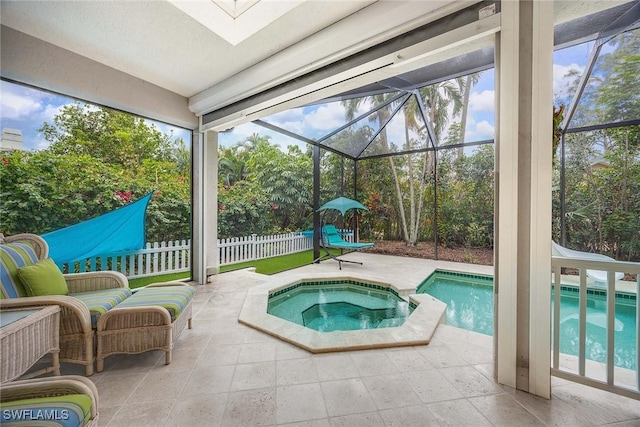 view of pool featuring a patio, an in ground hot tub, and glass enclosure