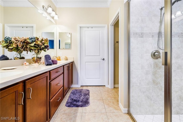 bathroom featuring tile patterned floors, a shower with door, vanity, and ornamental molding