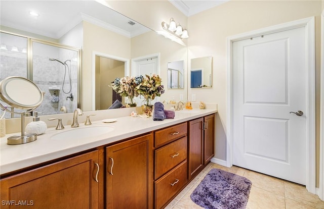 bathroom with tile patterned floors, vanity, a shower with shower door, and crown molding