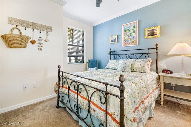 bedroom featuring ceiling fan, crown molding, and light colored carpet