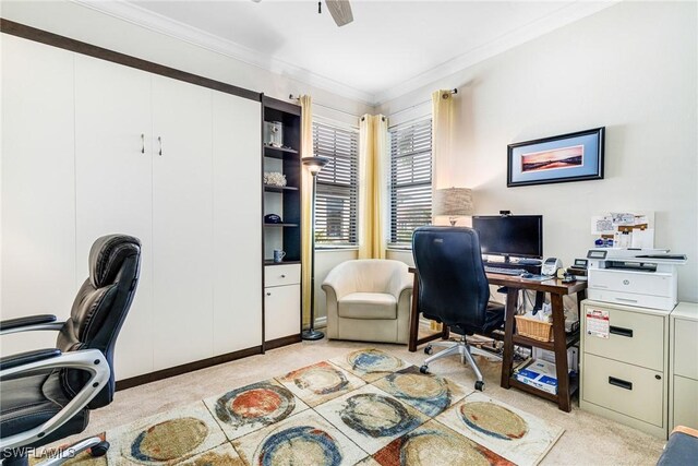 office space with ceiling fan, light colored carpet, and ornamental molding