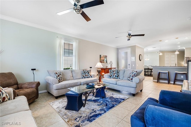 tiled living room with ceiling fan and ornamental molding