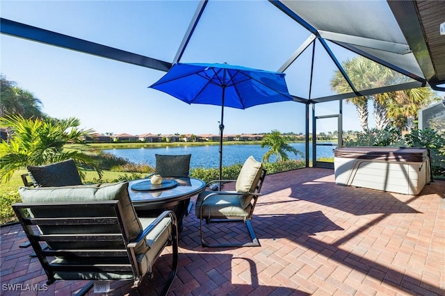 view of patio / terrace with a lanai and a water view