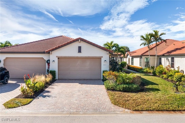 mediterranean / spanish house with a front yard and a garage