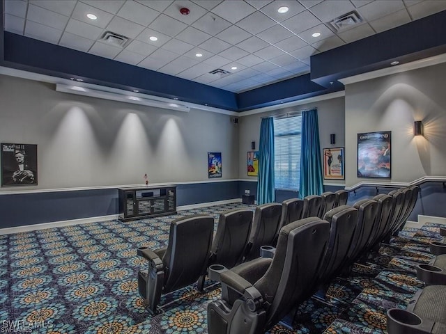 cinema room with carpet flooring and a paneled ceiling