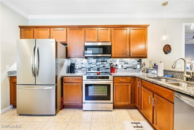 kitchen with backsplash, light stone counters, stainless steel appliances, sink, and pendant lighting