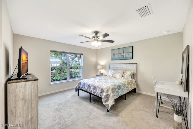 bedroom with ceiling fan and light carpet