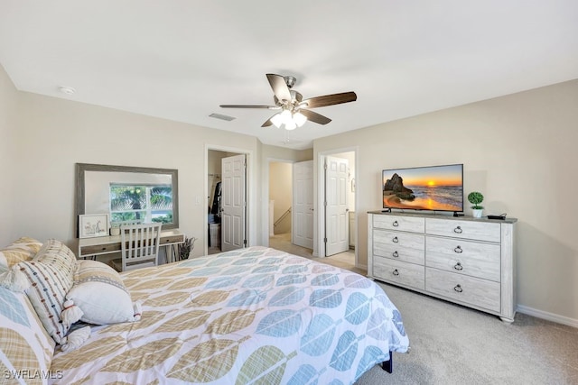 bedroom featuring ceiling fan, light colored carpet, a walk in closet, and a closet