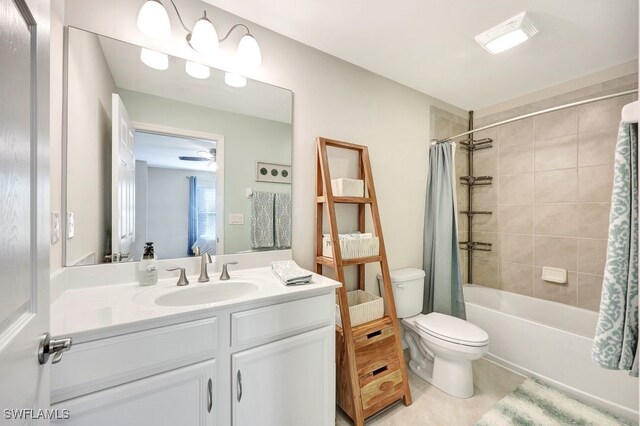 full bathroom featuring vanity, tile patterned floors, ceiling fan, toilet, and shower / bath combo with shower curtain