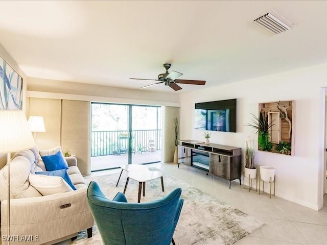 tiled living room with ceiling fan