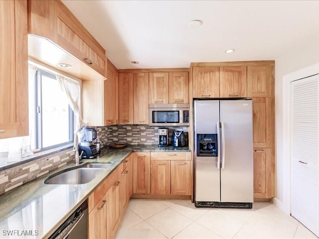 kitchen with sink, light tile patterned floors, stainless steel appliances, and tasteful backsplash